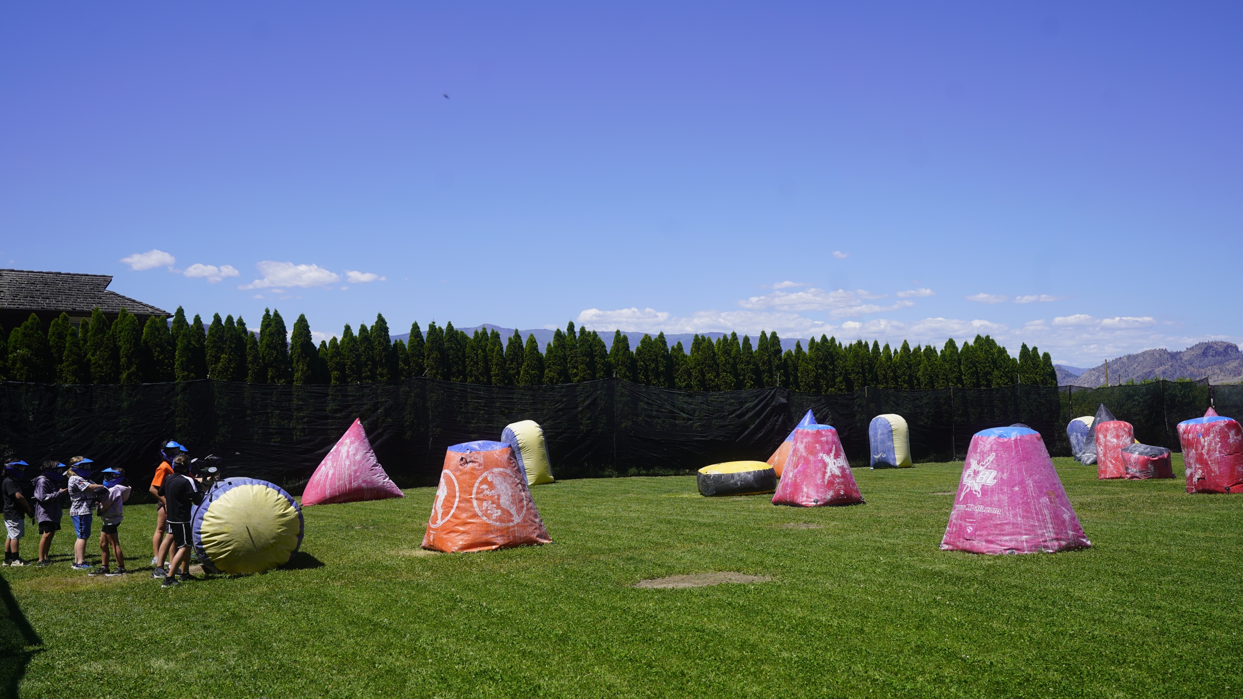 Youth lined up to play paintball in the obstacle course at Osoyoos Paintball