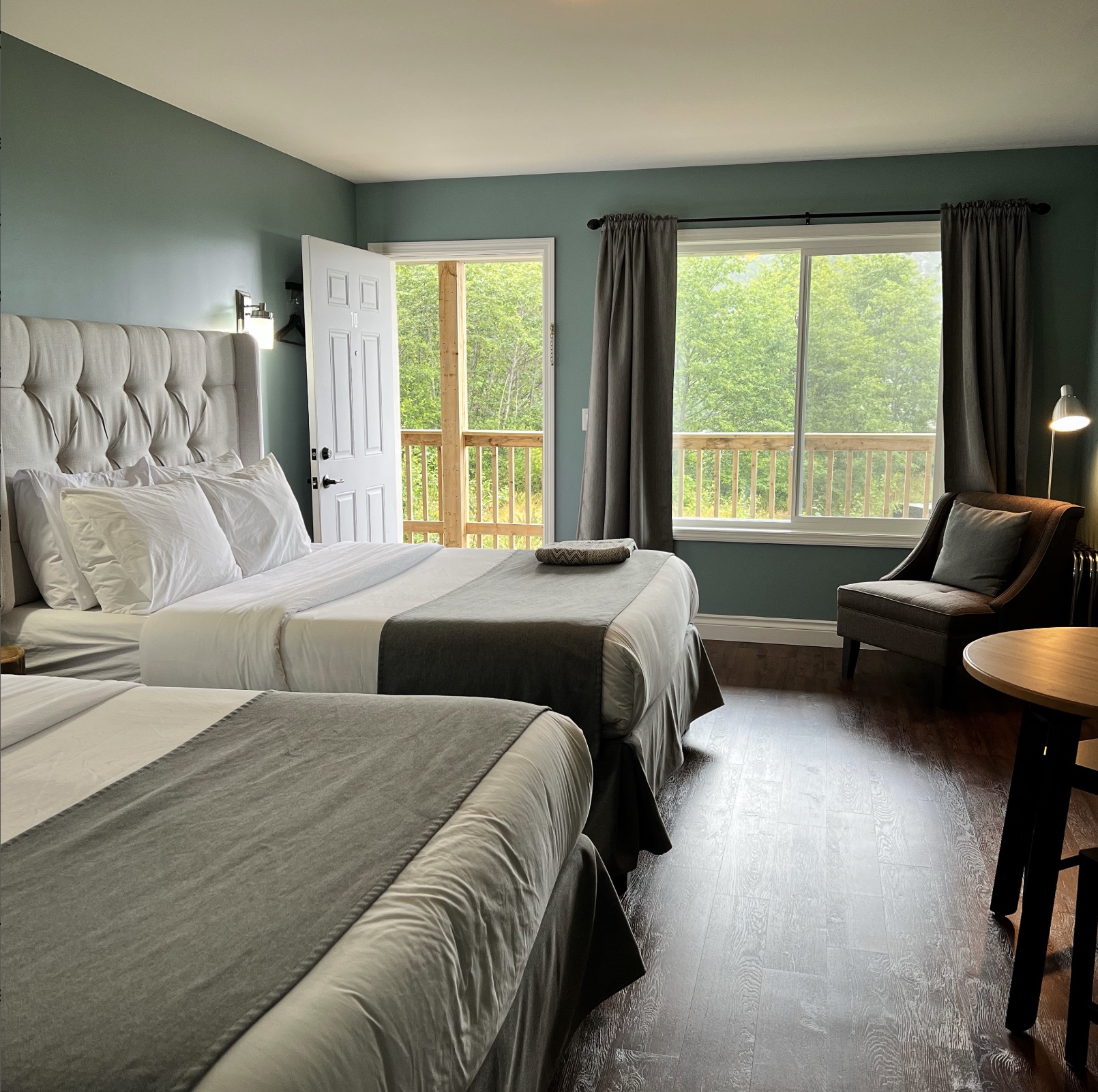 Guest room with two beds and a chair at Jag's Coffee and Guesthouse in Haida Gwaii