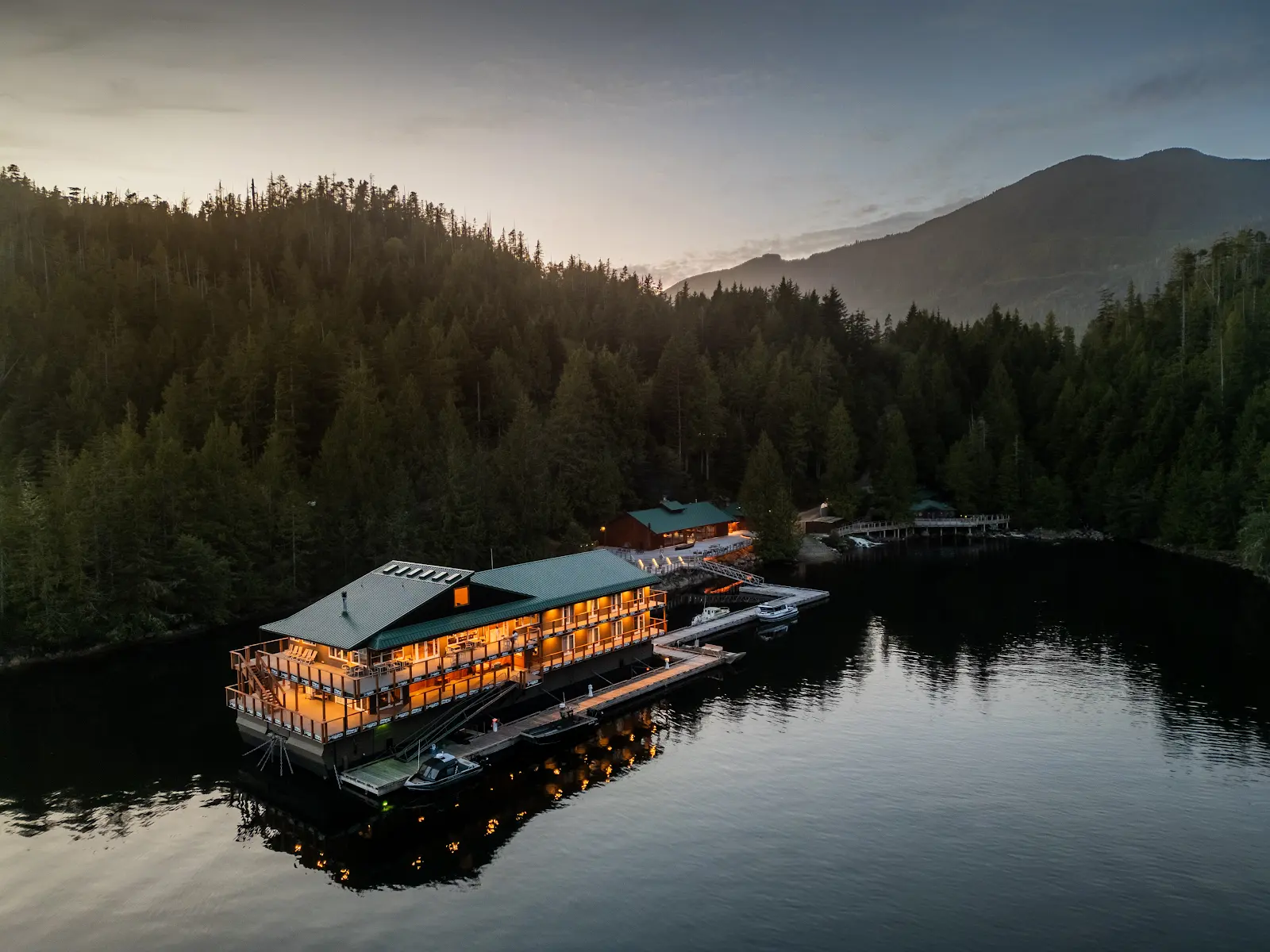 Wahous Wilderness Lodge. floating lodge in evening light in the calm, Quait Bay near Tofino.