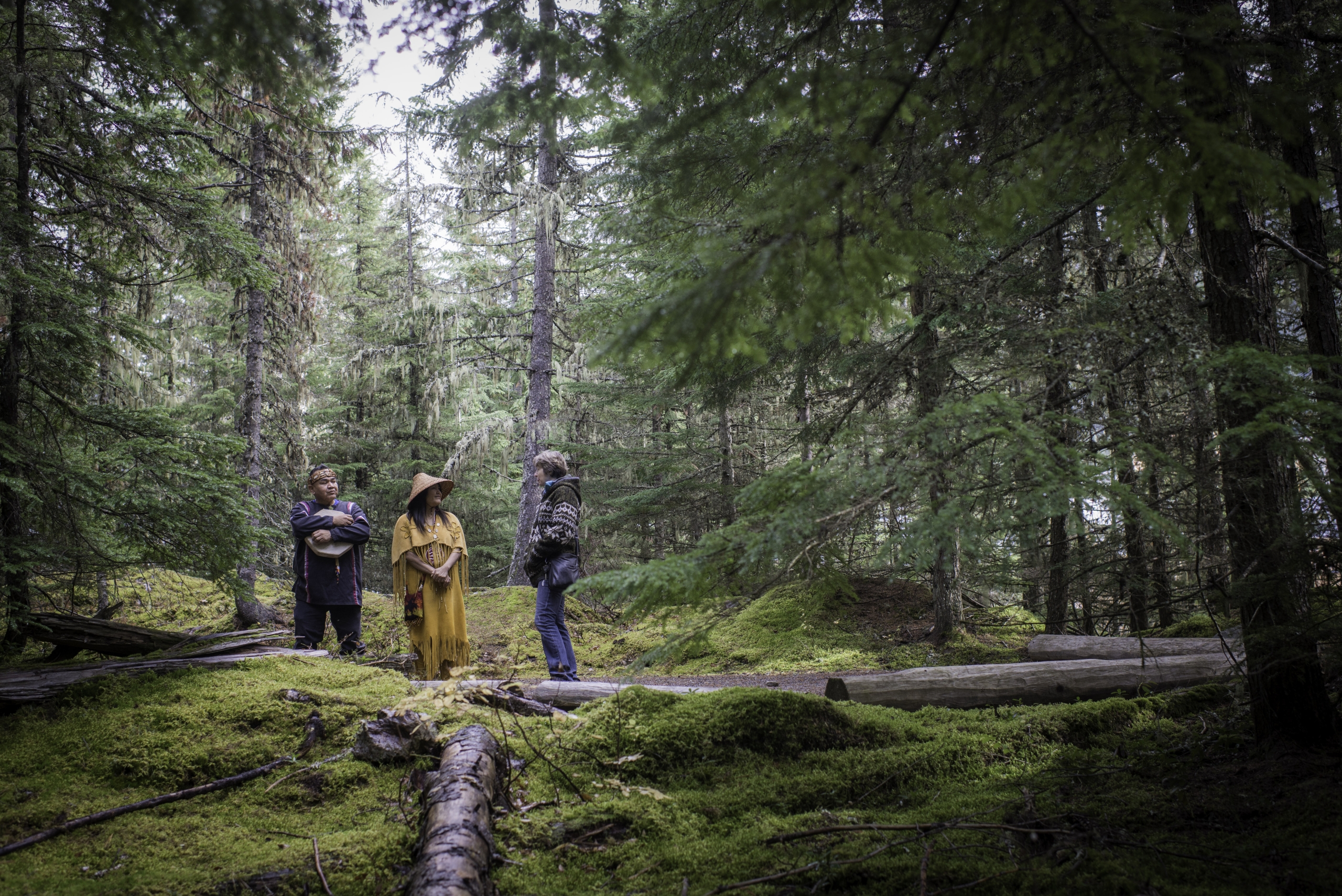 Tourist with Indigenous guides on the cultural tour in the forest with the Squamish Lil'wat Cultural Centre in Whistler, BC
