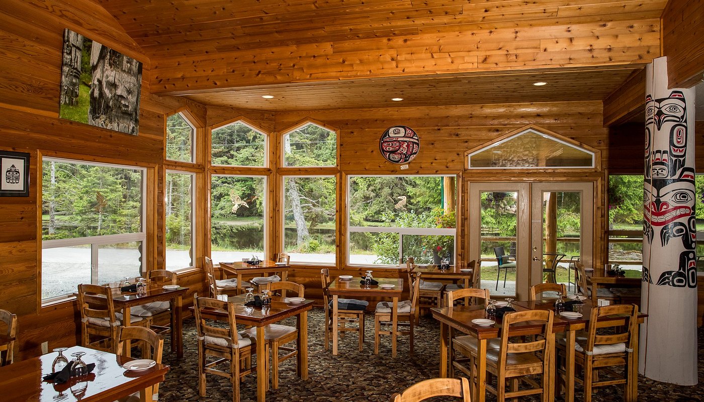 Haida House Dinning Room in Haida Gwaii; showcasing Haida art and scenic outdoor view.