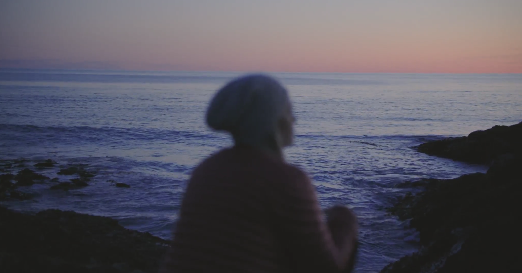 woman sitting at tofino beach