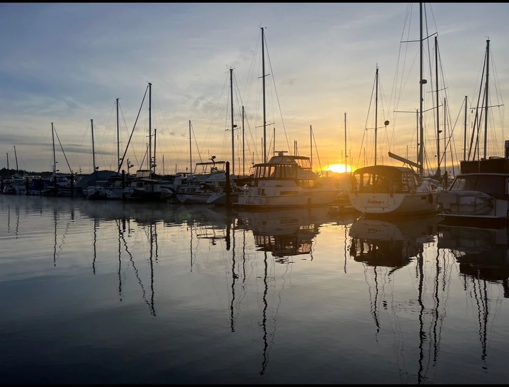 boats in Campbell River marina on calm ocean at sunset