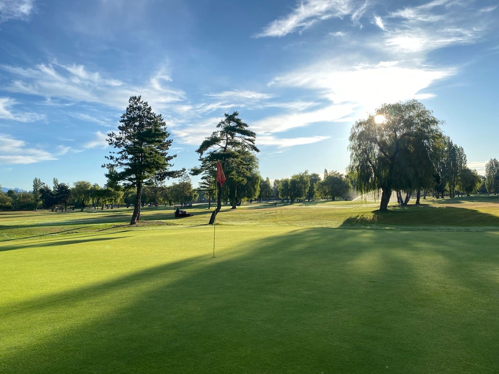 Green fairway and trees with a blue sky at Musqueam Golf Course in Vancouver BC