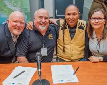 ITBC and Tourism Vancouver Island members smile after signing an MOU