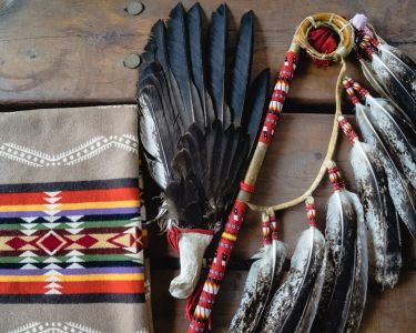 A collection of traditional Indigenous items laid on wooden boards.