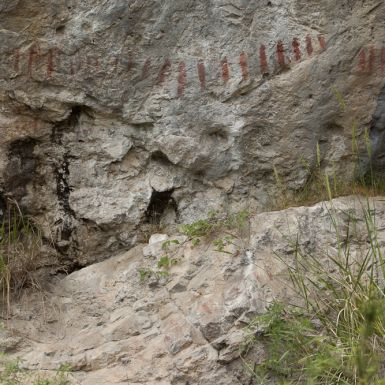 A rock wall with red and black markings