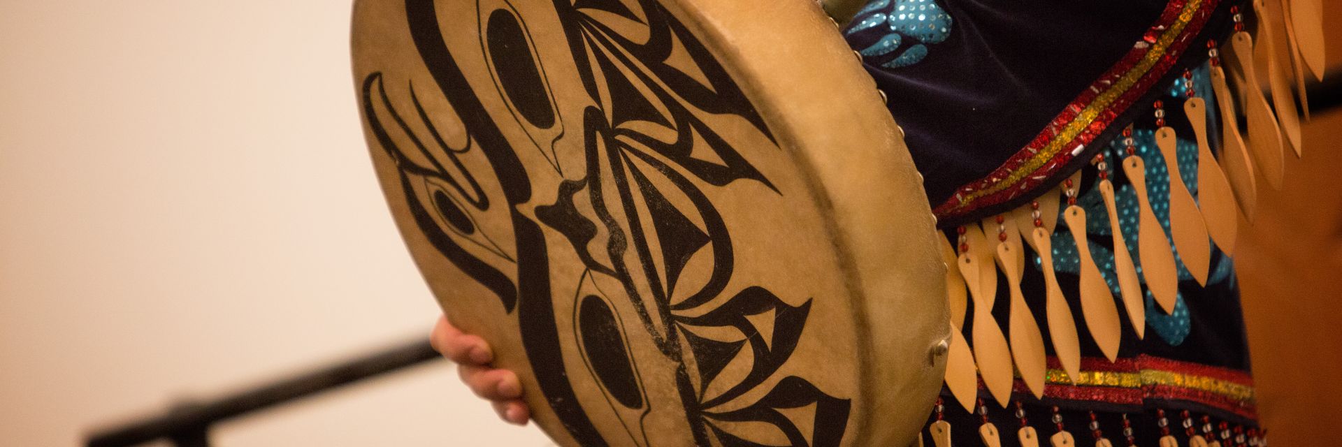 A closeup of an Indigenous drum with intricate black designs