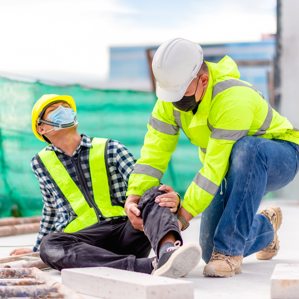 A construction worker helping another construction worker with their bad leg